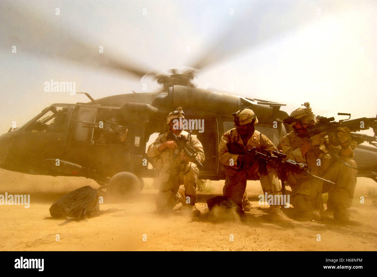 The rotor wash of a UH60 Black Hawk helicopter kicks up clouds of dust