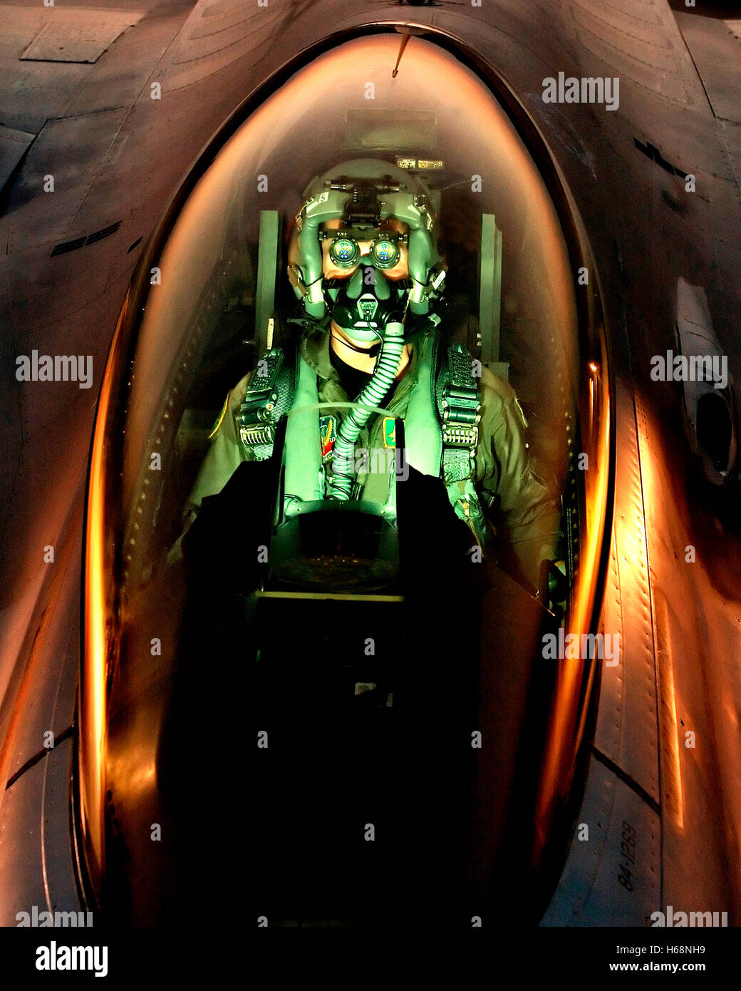 An F16 pilot peers through his night vision goggles. DoD photo by