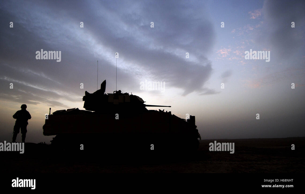 A soldier stands lookout by his M3A3 Bradley Cavalry Fighting Vehicle during a combat security patrol outside Ancient Samarra, near Ad Dwr, Iraq. DoD photo by Staff Sgt. Shane A. Cuomo U.S. Air Force Stock Photo