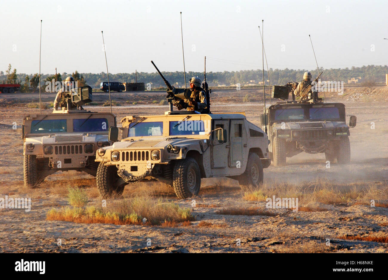 U.S. Army soldiers of the 1st Infantry Division position their Humvees near a house they are clearing to use as an observation point outside Baqubah, Iraq, on Aug. 19, 2004.  DoD photo by Pfc. Elizabeth Erste, U.S. Army Stock Photo