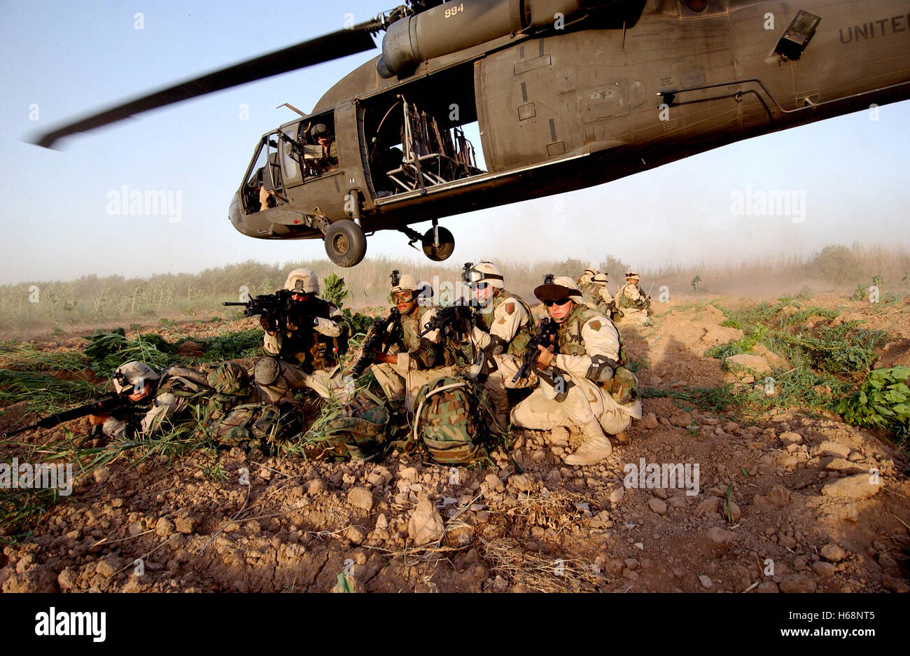 Members of Bravo Section, 2nd Brigade Recon Troop, brace themselves in a security posture after being infiltrated by a UH-60A Black Hawk helicopter during a Quick Response Force Weapons Interdiction mission in Iraq. DoD photo by Tech. Sgt. Scott Reed, U.S. Air Force Stock Photo