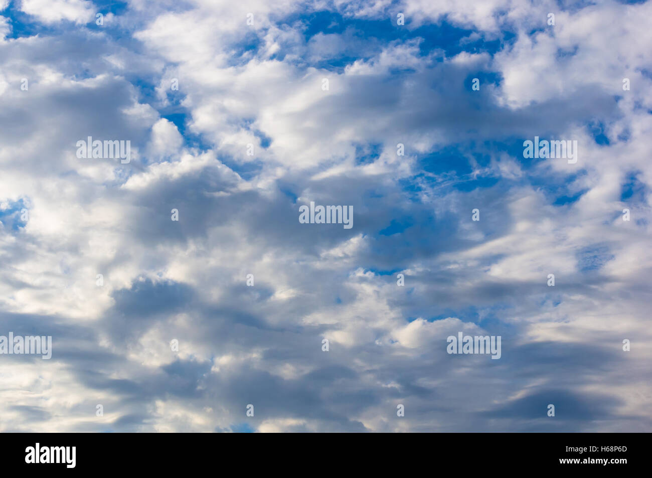 White clouds with sun rays in the blue summer sky Stock Photo Alamy