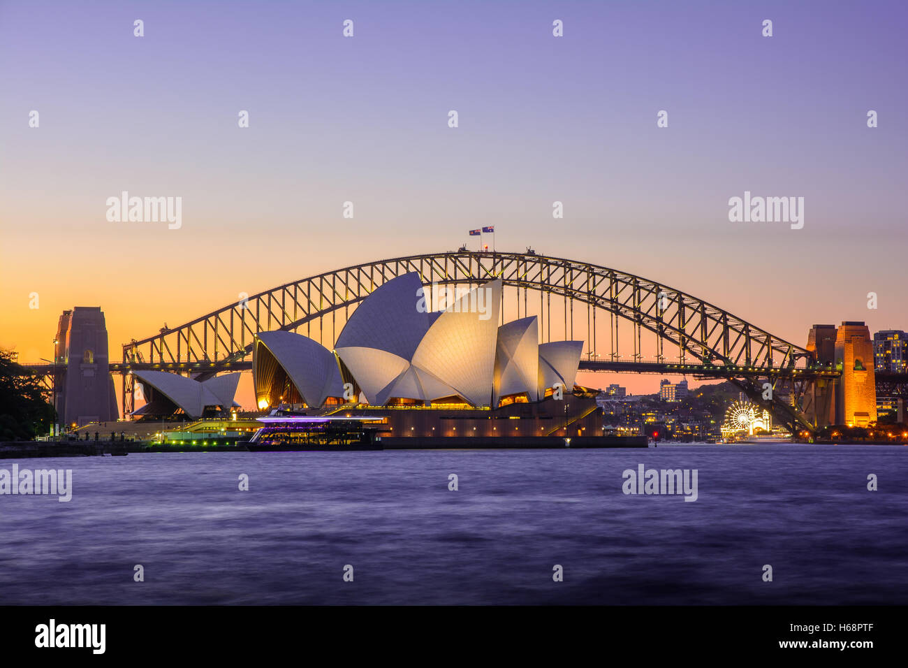 Sydney Bay Sunset View with Sydney Opera House, Skyline and Bridge - Australia Stock Photo