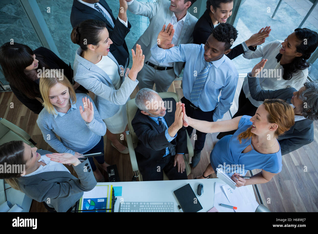 Businesspeople giving high five to each other Stock Photo