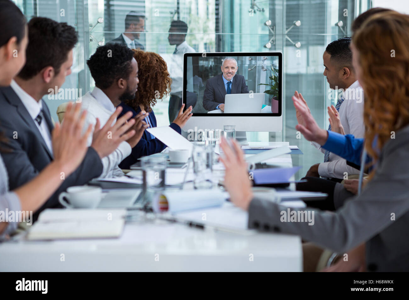 Business people looking at a screen during a video conference Stock Photo