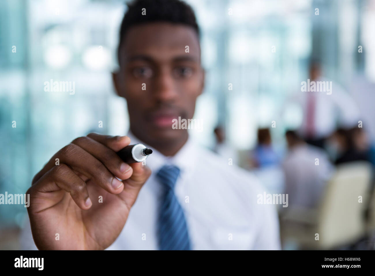 Businessman writing with marker on glass Stock Photo Alamy