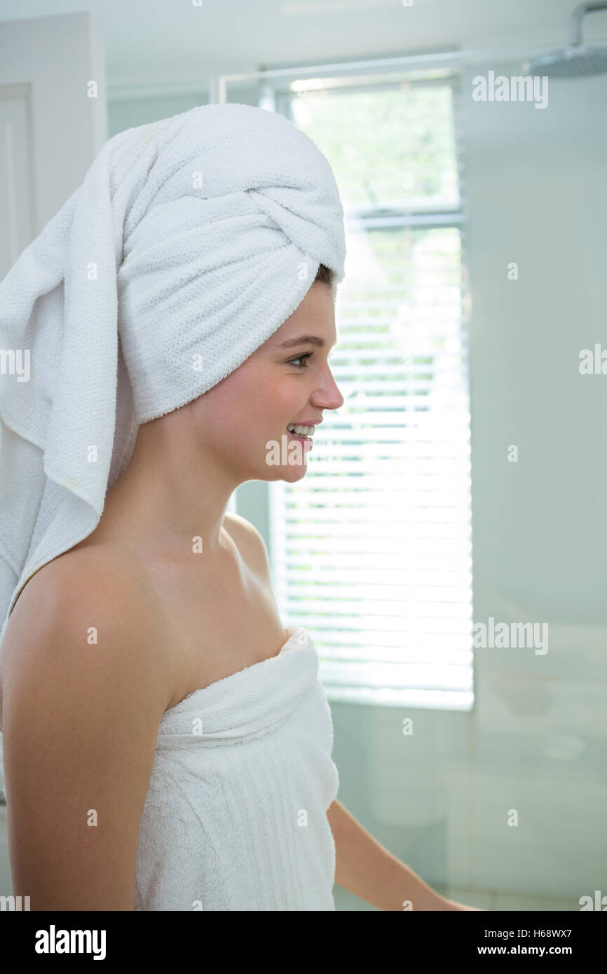 Woman in a bathrobe with a towel on her head Stock Photo
