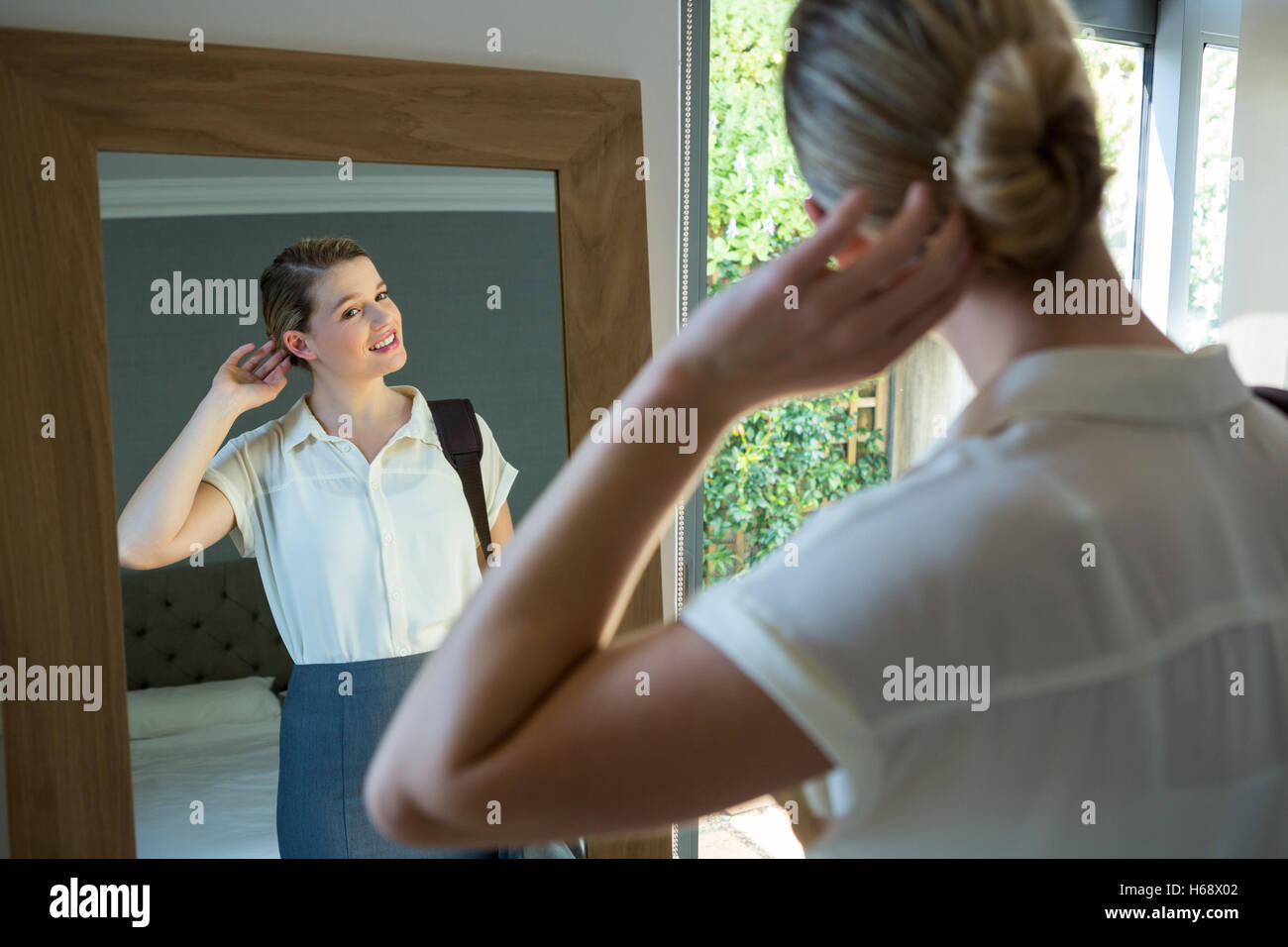 Woman getting ready for office in bedroom Stock Photo