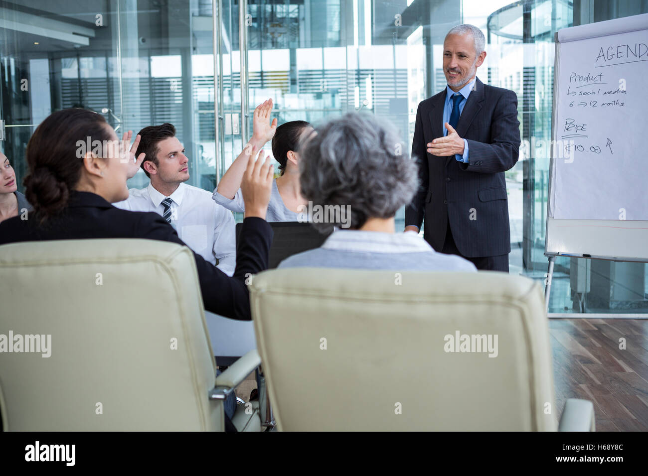 Businessman interacting with coworkers Stock Photo