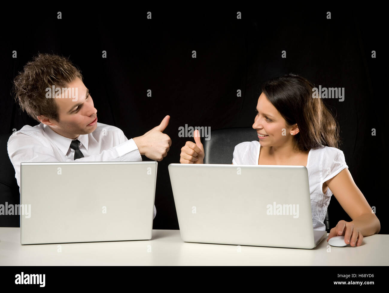 Successful business people with thumbs up Stock Photo - Alamy