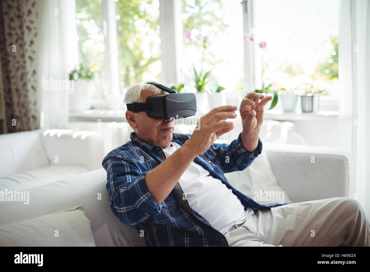 Senior man wearing virtual glasses Stock Photo