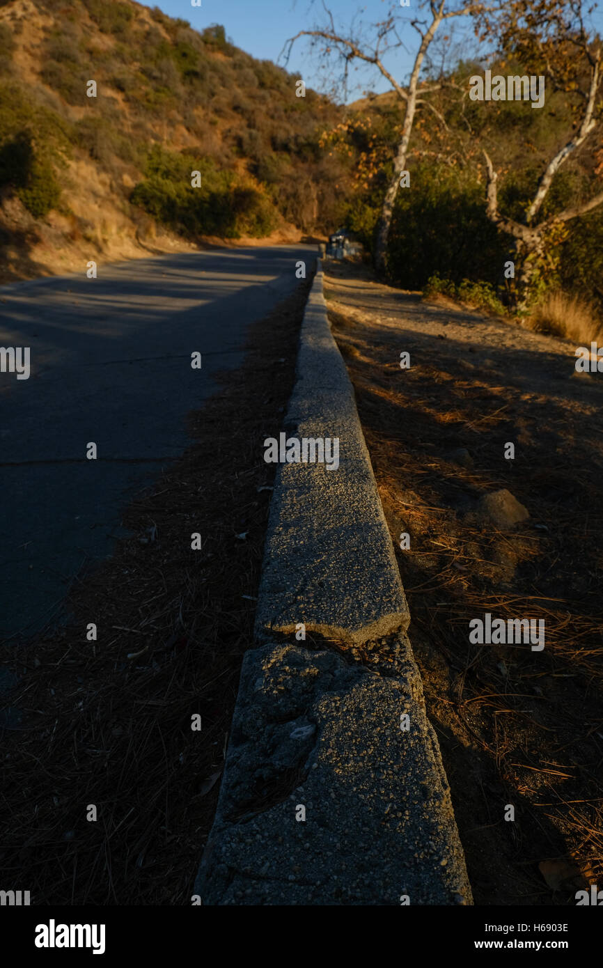 Cracked curb, lines leading in a straight line down the frame Stock Photo