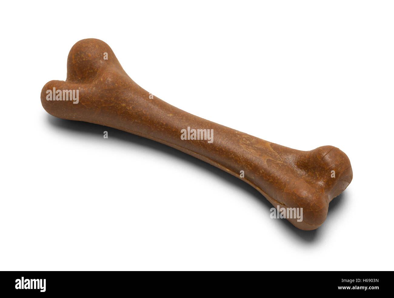 Single Brown Chewy Dog Bone Isolated on White Background. Stock Photo