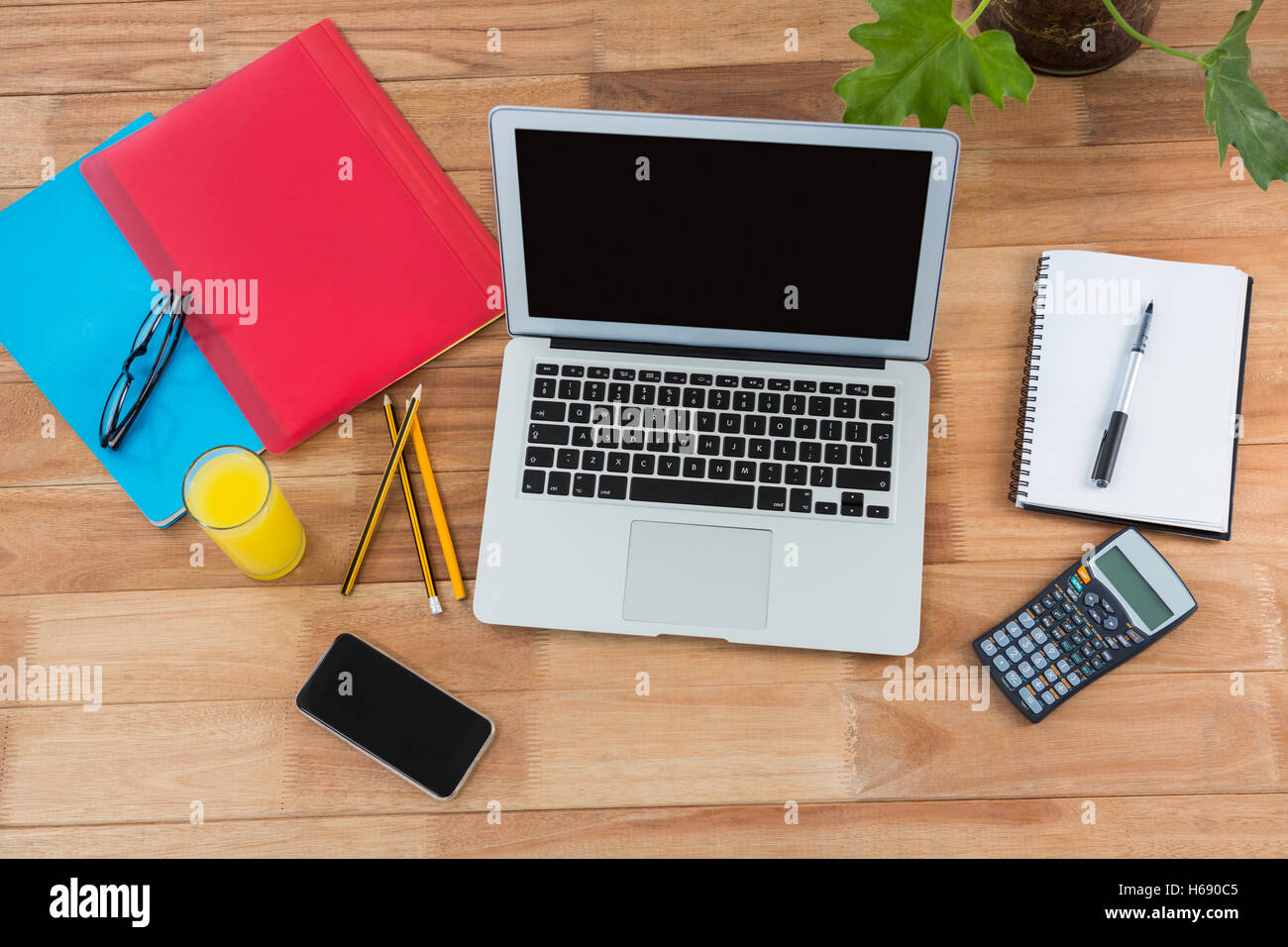 Office accessories with mobile phone and laptop Stock Photo - Alamy