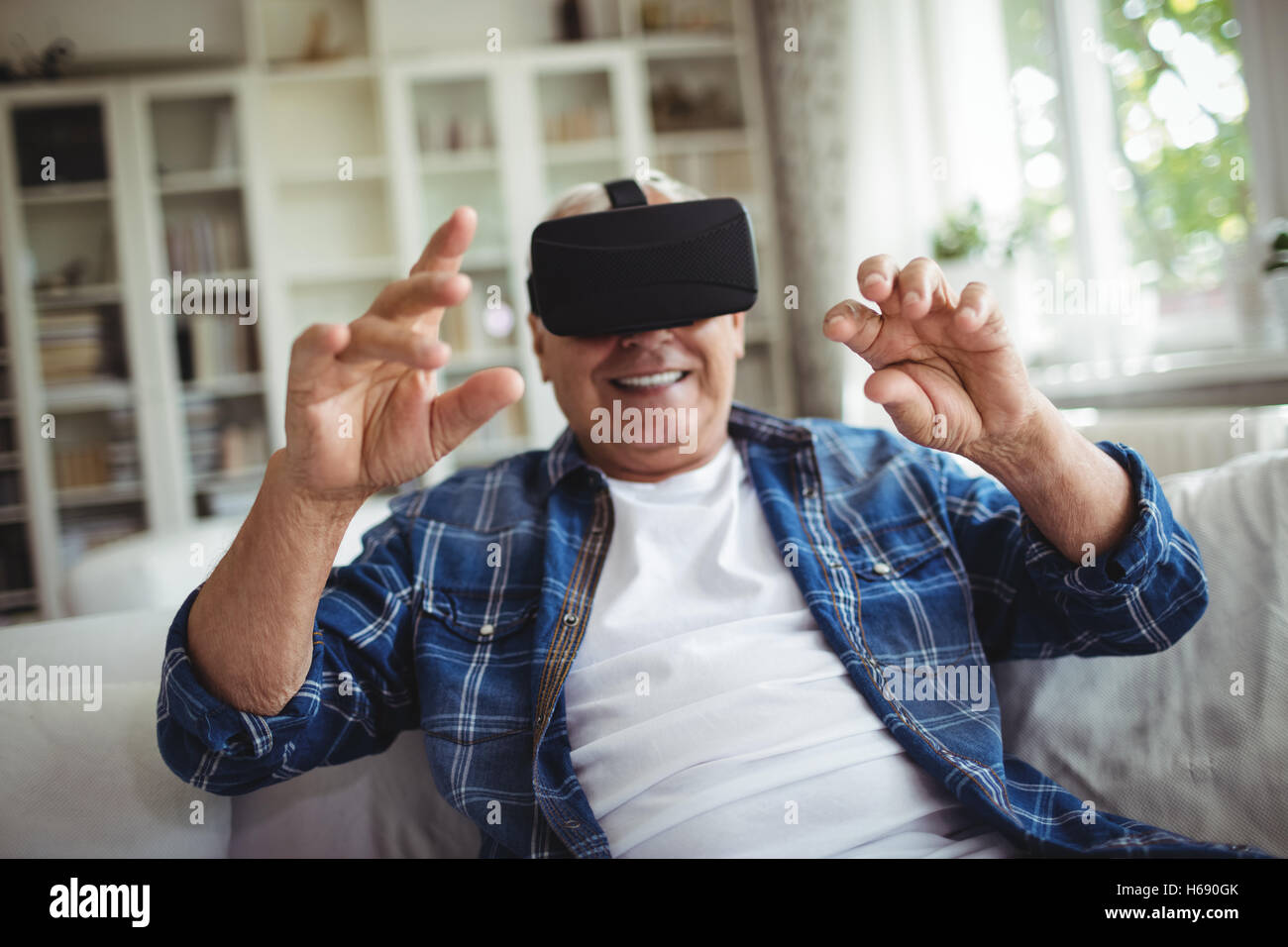 Senior man wearing virtual glasses Stock Photo