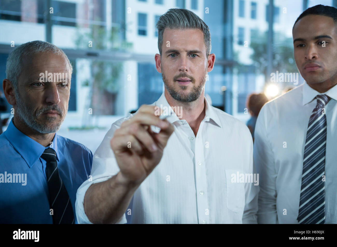 Businessman writing with marker on glass Stock Photo - Alamy