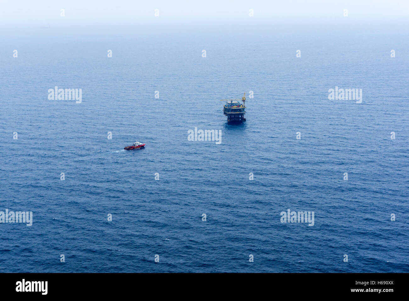 Anchor handling tug approaching oil rig or platform during anchor handling operations Stock Photo