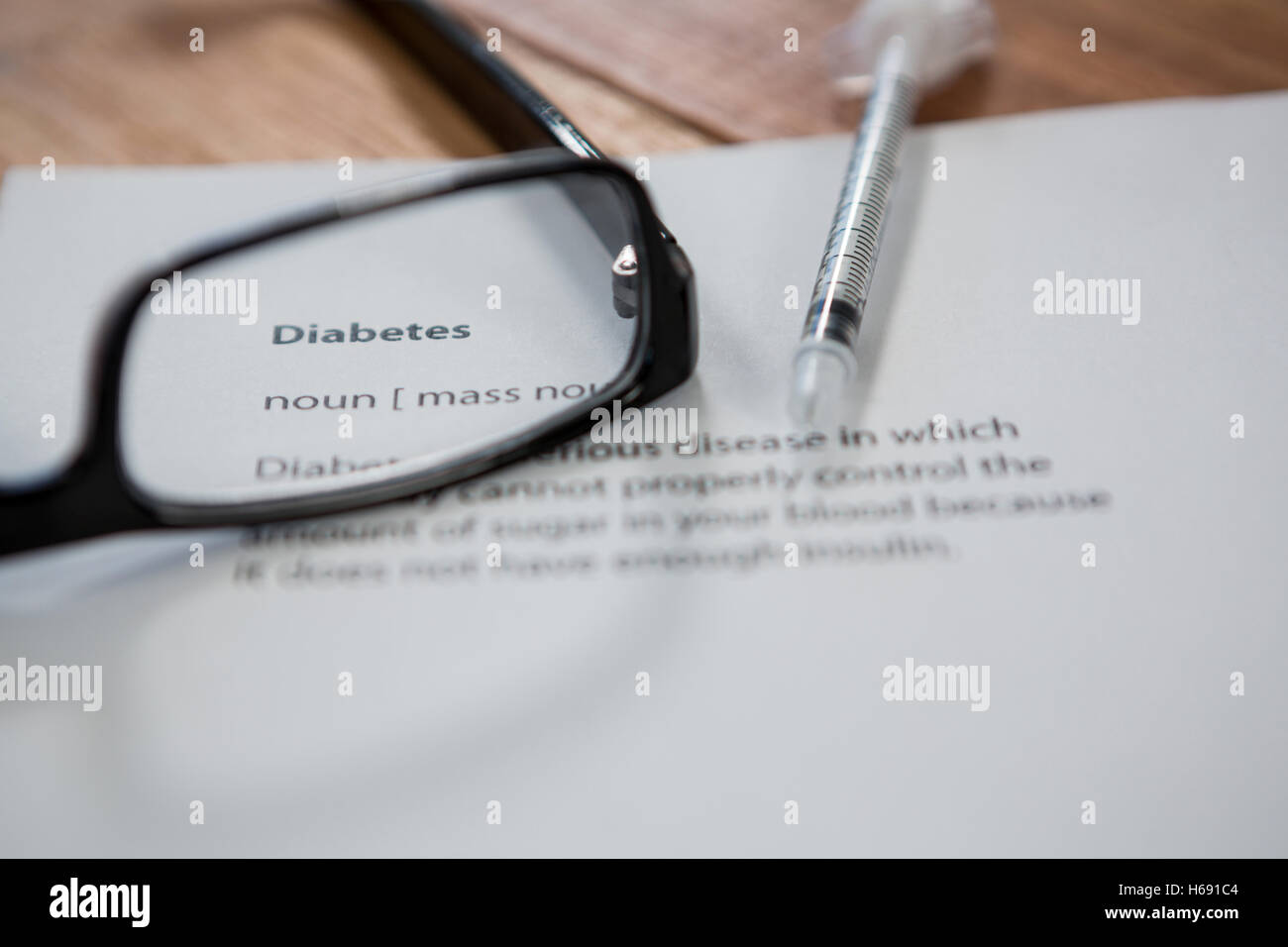 Close-up of injection with diabetes test paper and spectacle Stock Photo
