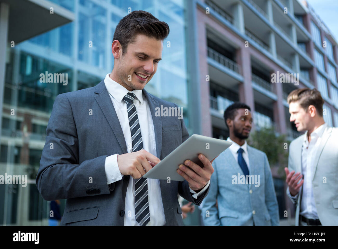 Businessman using digital tablet in the office building Stock Photo - Alamy