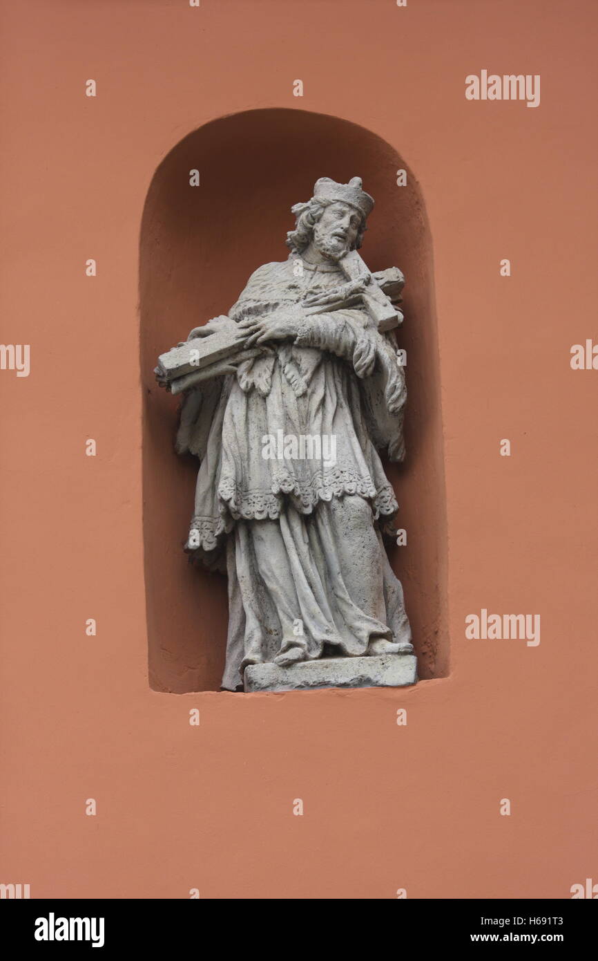 A niche with a statue of Saint John of Nepomuk (Nepomuki Szent Janos) holding a cross, Castle District, Budapest, Hungary Stock Photo
