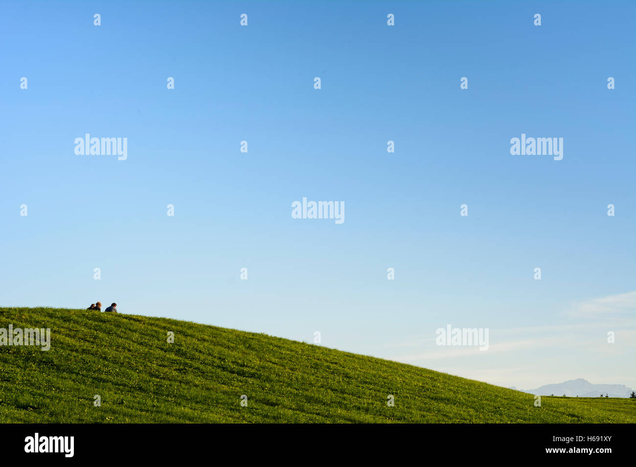 Hohenpeißenberg: 3 young men sitting at hill, meadow, view to Alps, space, Oberbayern, Upper Bavaria, Bayern, Bavaria, Germany Stock Photo