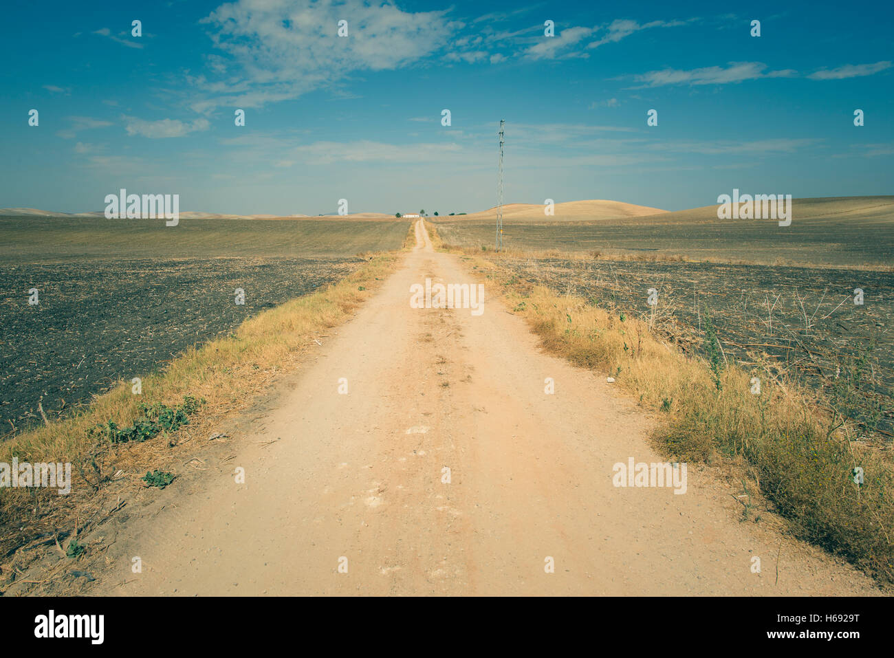 Vintage dirt road and blue sky Stock Photo - Alamy