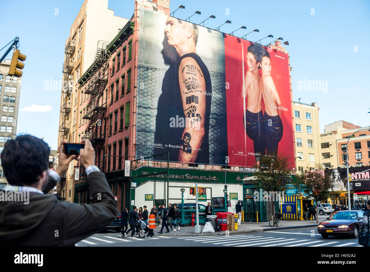 New York, USA 23 October 2016 - Man taking a photo of billboard advertising  for Calvin Klein. featuring Henry Rollins and Bella Hadid ©Stacy Walsh  Rosenstock Stock Photo - Alamy