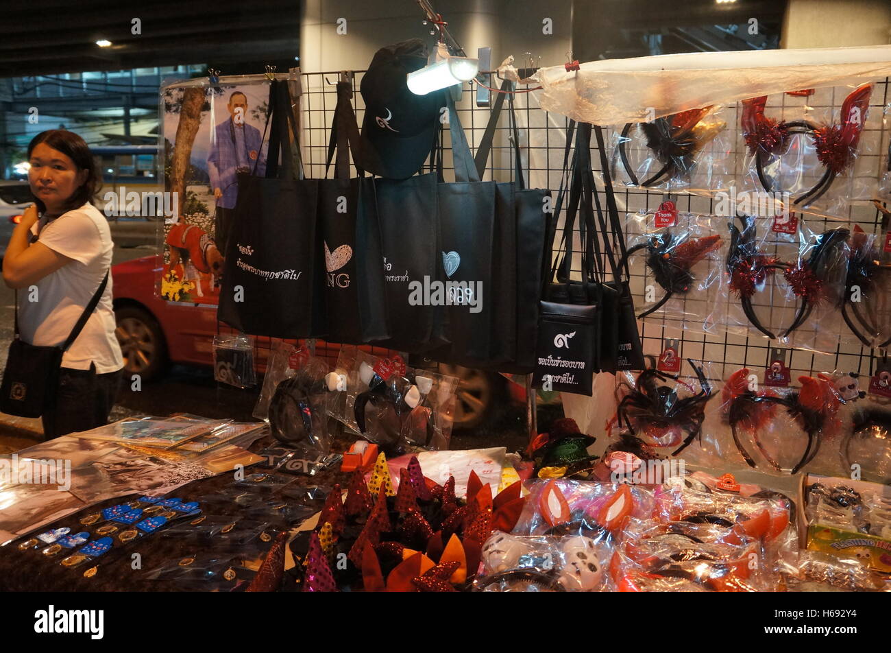A female vendor in front of her stall selling knickknack and bags with