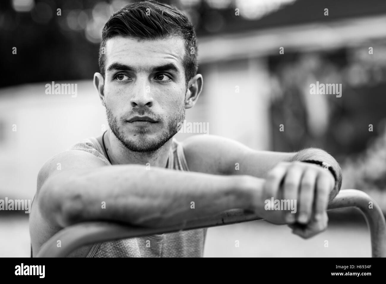 Black and white portrait of sporty man relaxing after training Stock Photo