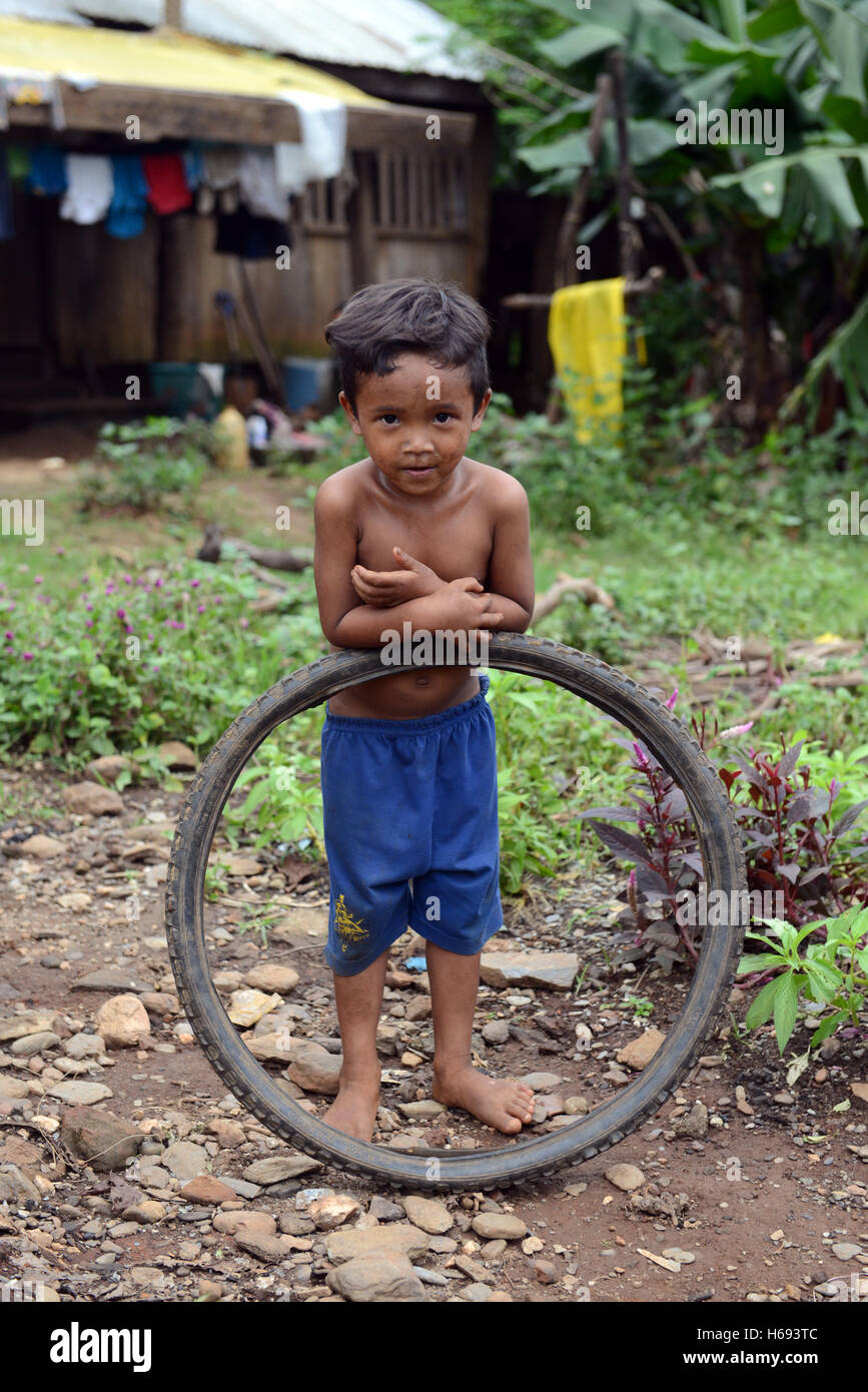 A cute Iraya Mangyan boy playing with a wheel Stock Photo Alamy