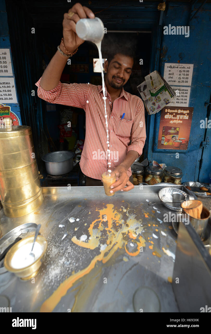 A Chai Wallah preparing traditional Indian Chai ( milk tea ) in Madurai