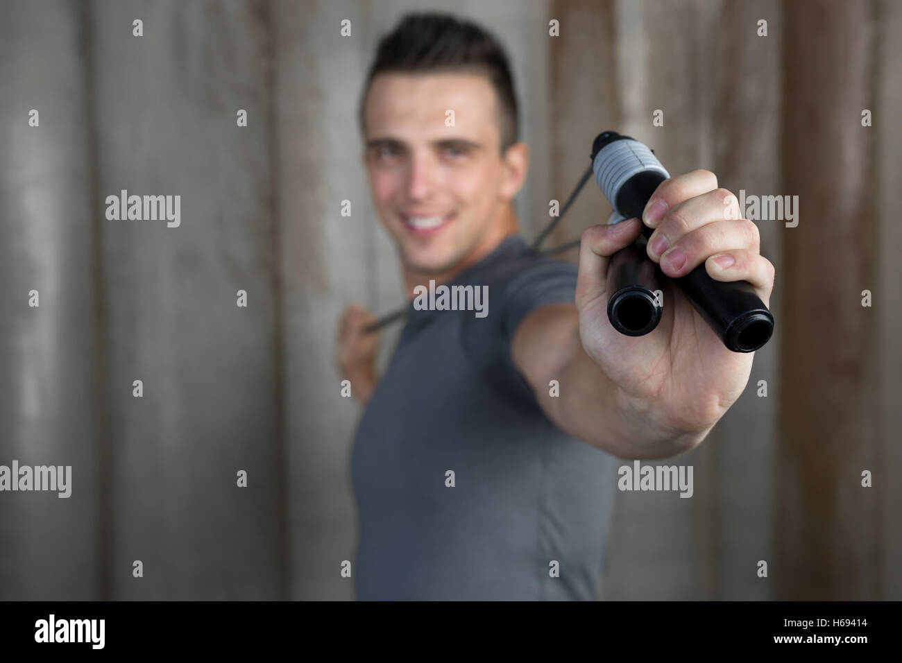 Handsome muscular man with jumping rope on rustic background Stock ...