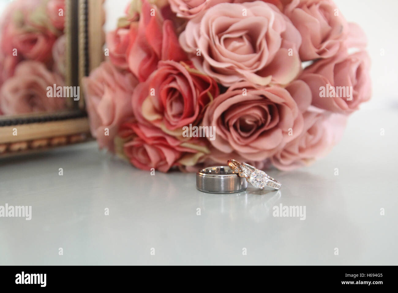 Wedding rings and bouquet Stock Photo