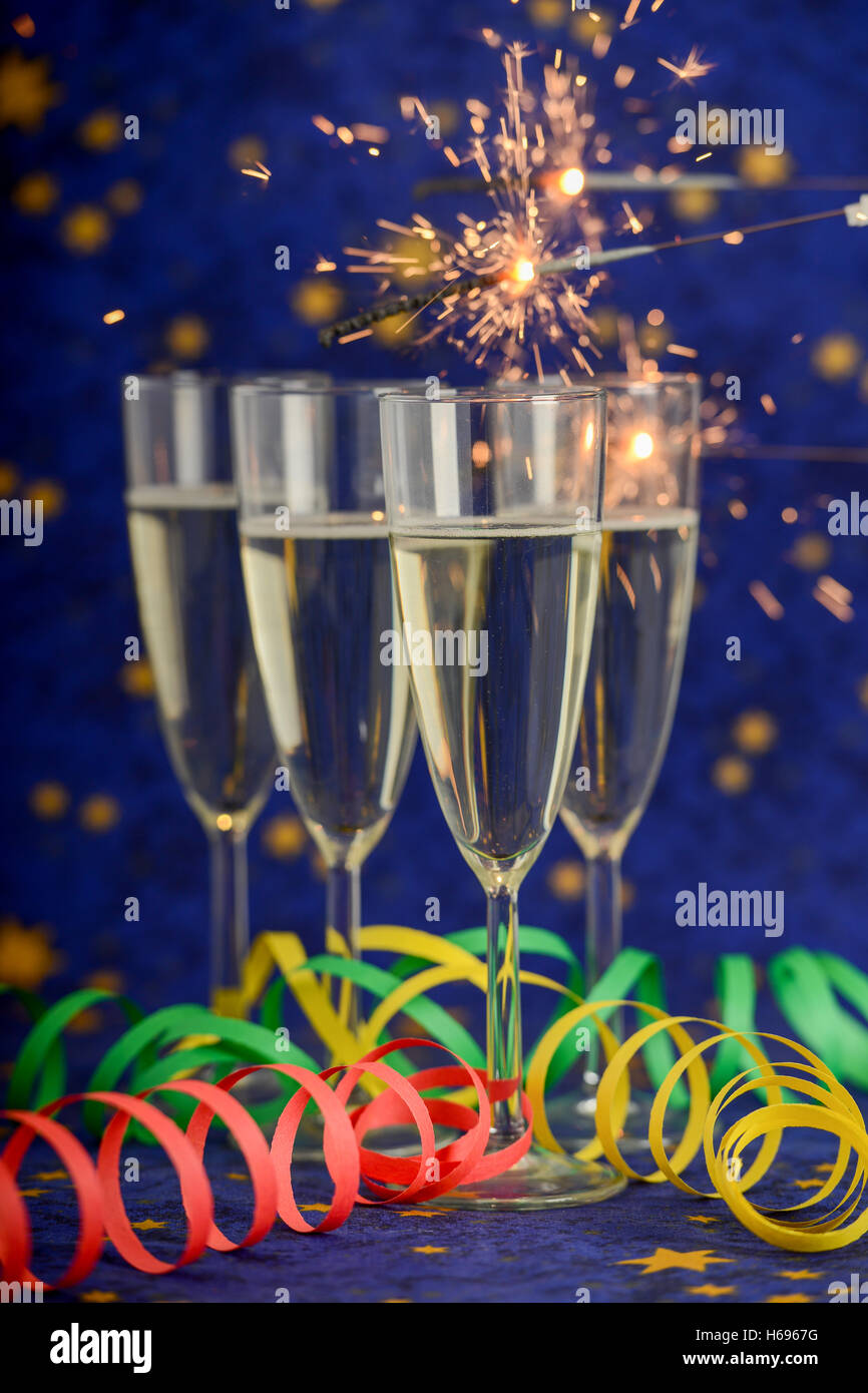 New Year celebration. Glasses with champagne against holiday lights ...