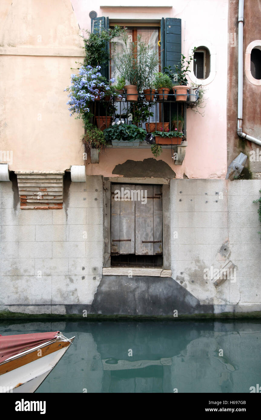 Beside a canal in Venice a resident has created a flourishing window garden Stock Photo