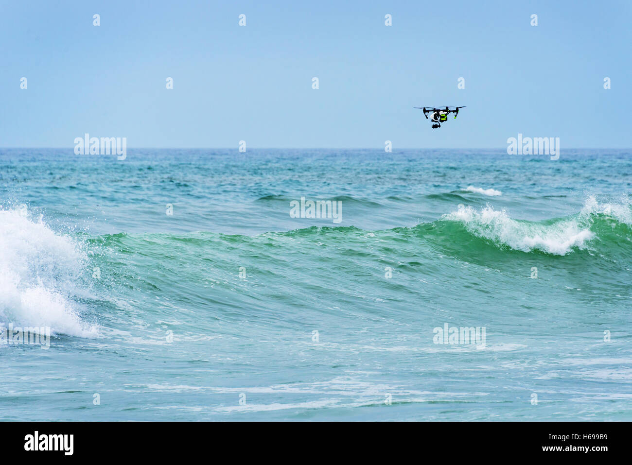 Drone flying over the waves on the ocean Stock Photo