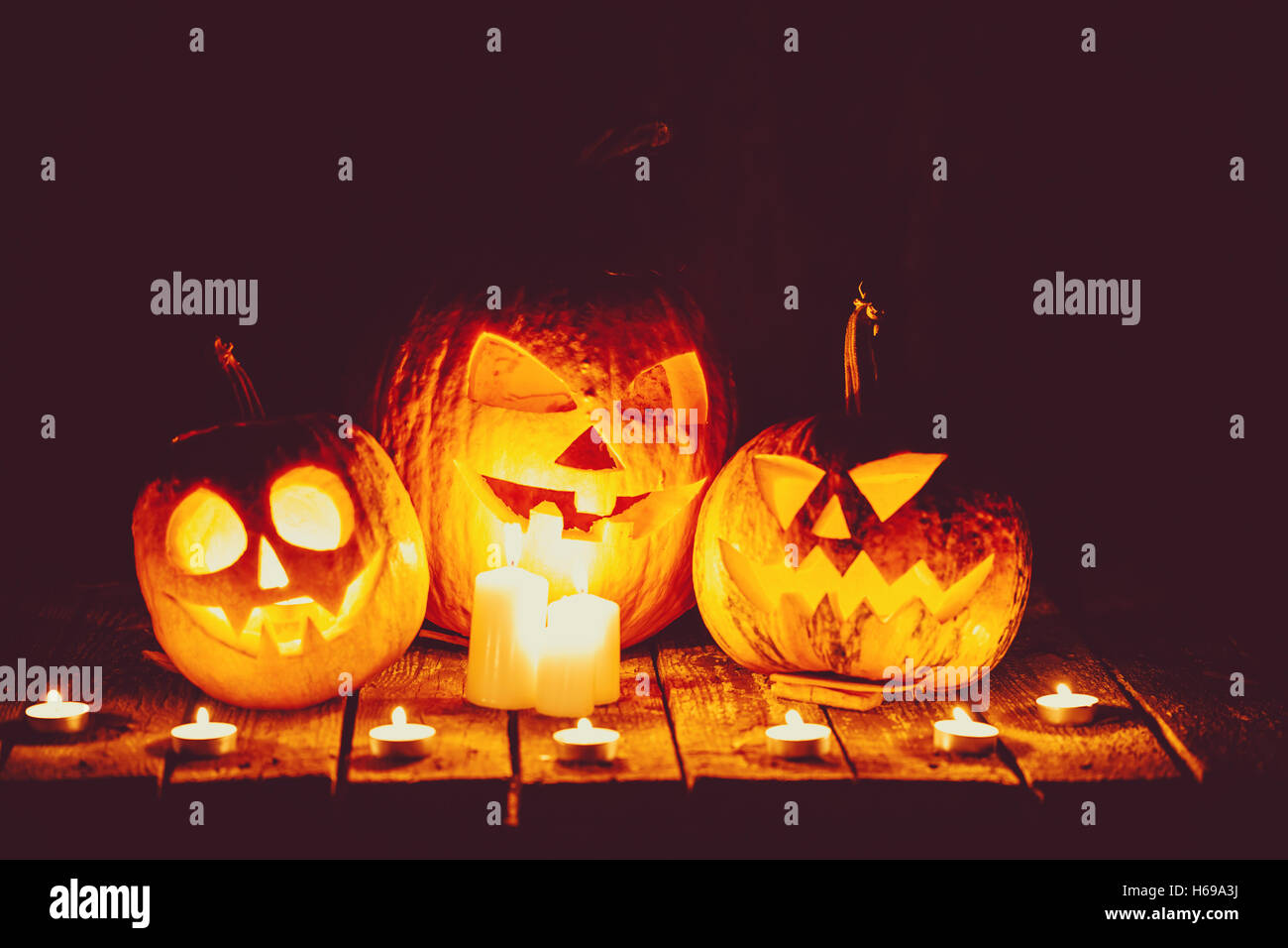 Halloween Pumpkins head jack lantern on the old boards in a spooky ...