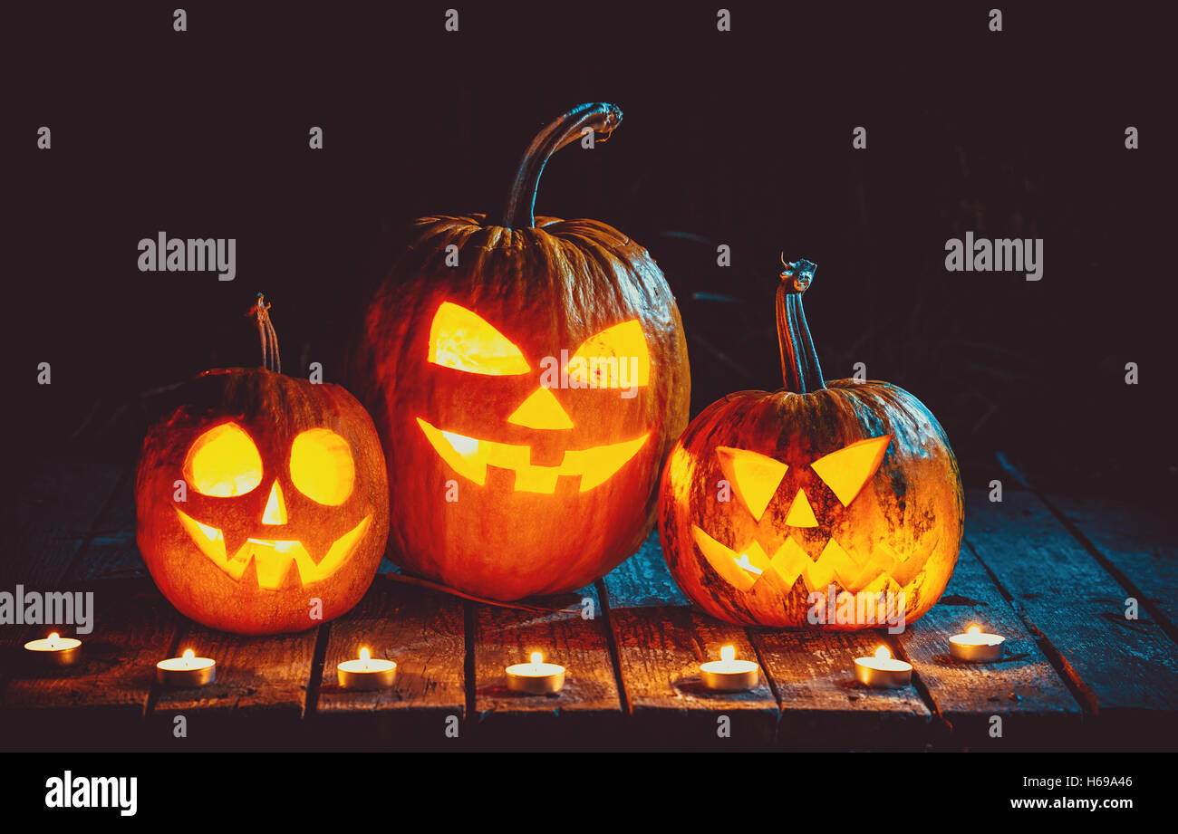 Halloween Pumpkins head jack lantern on the old boards in a spooky ...
