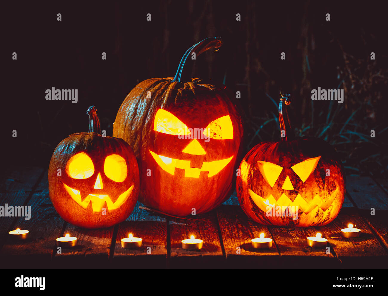 Halloween Pumpkins head jack lantern on the old boards in a spooky ...
