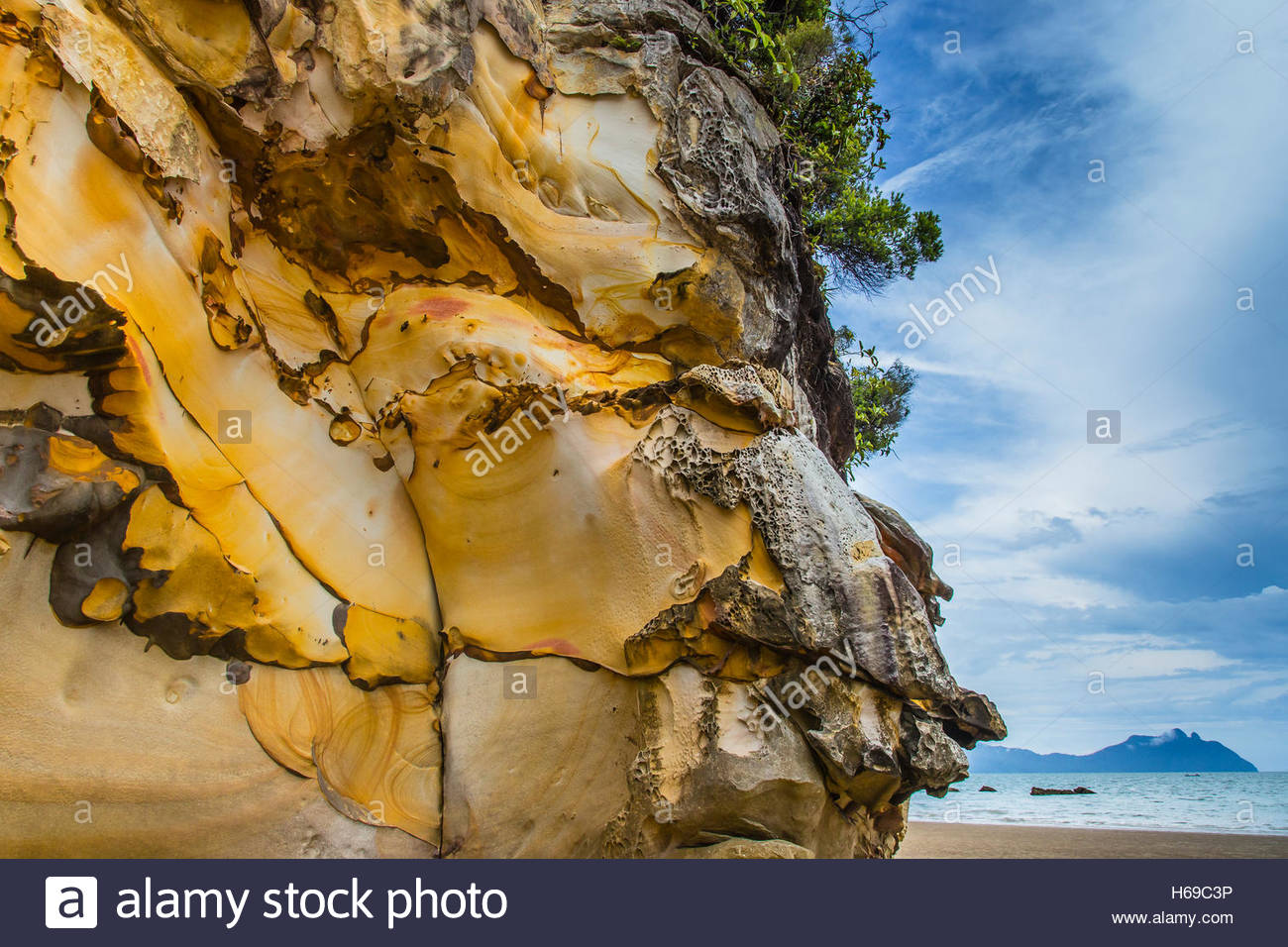Erosion evidence is clear on waterside rock formations. Stock Photo
