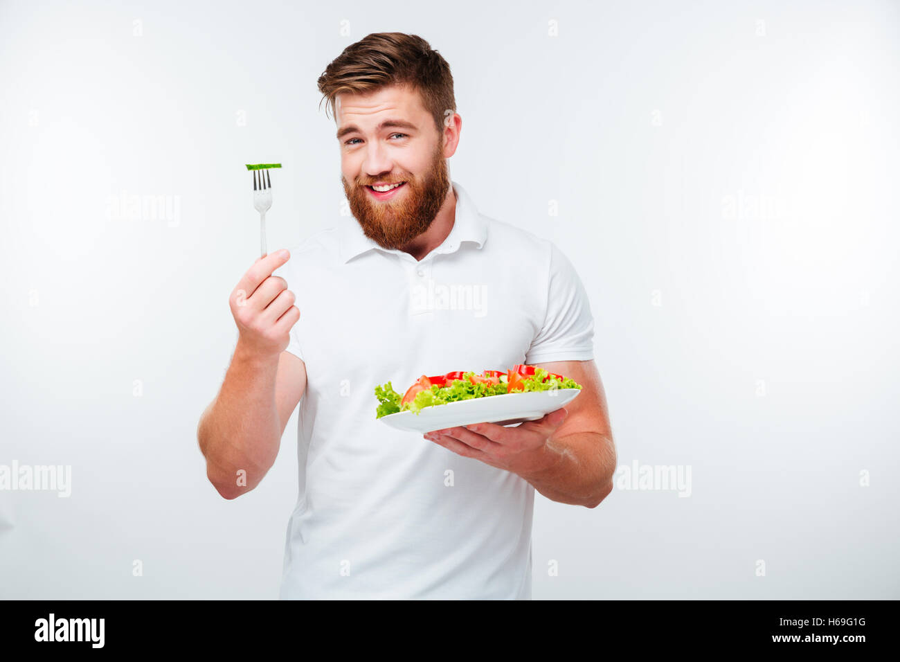 Young man is a happy salad tosser Stock Photo by ©lofilolo 30031259