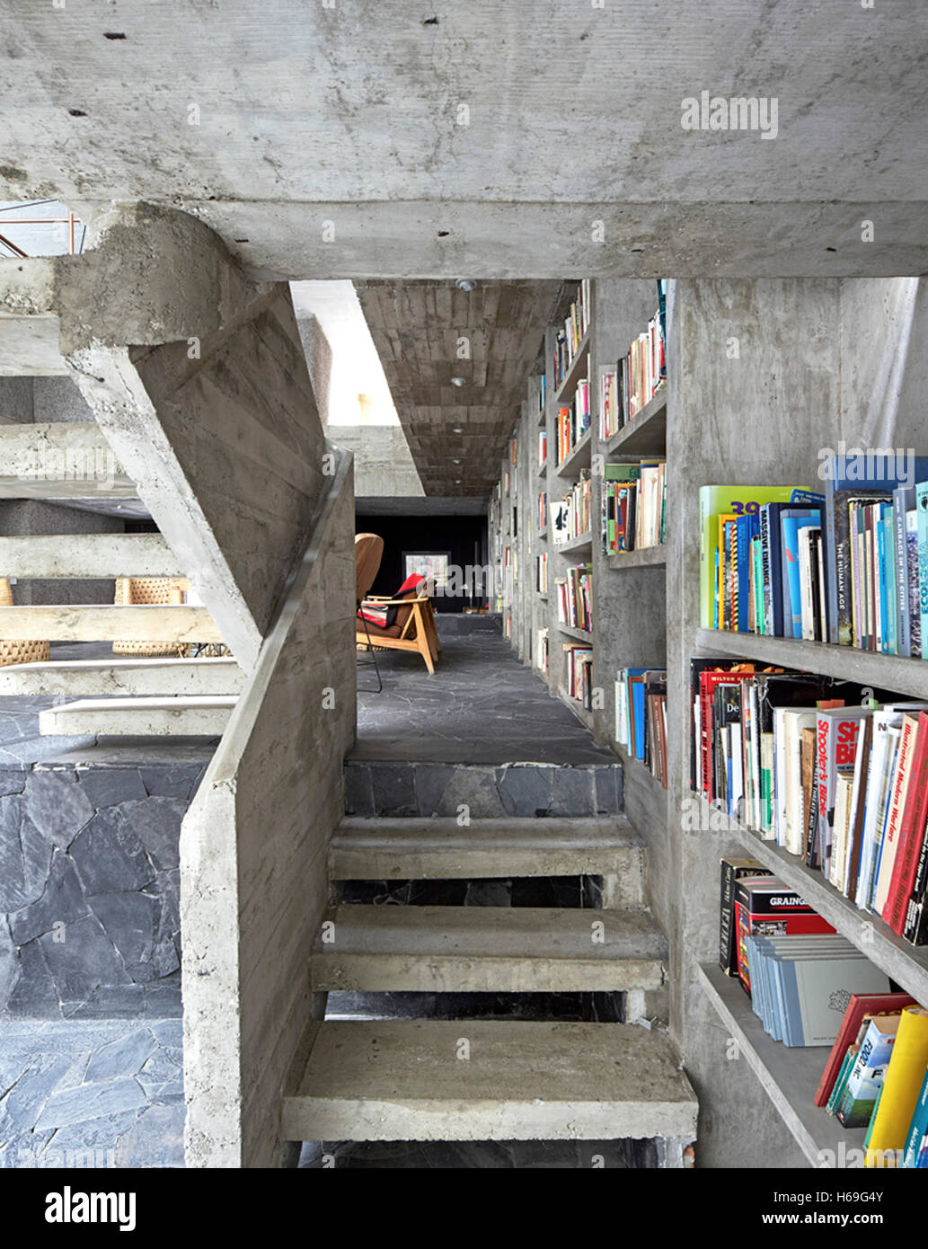 Interior view from under exposed concrete stair. Pedro Reyes House, Mexico City, Mexico. Architect: N/A , 2015. Stock Photo