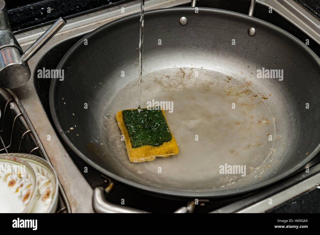 a dirty pan in the kitchen sink waiting for cleaning Stock Photo Alamy