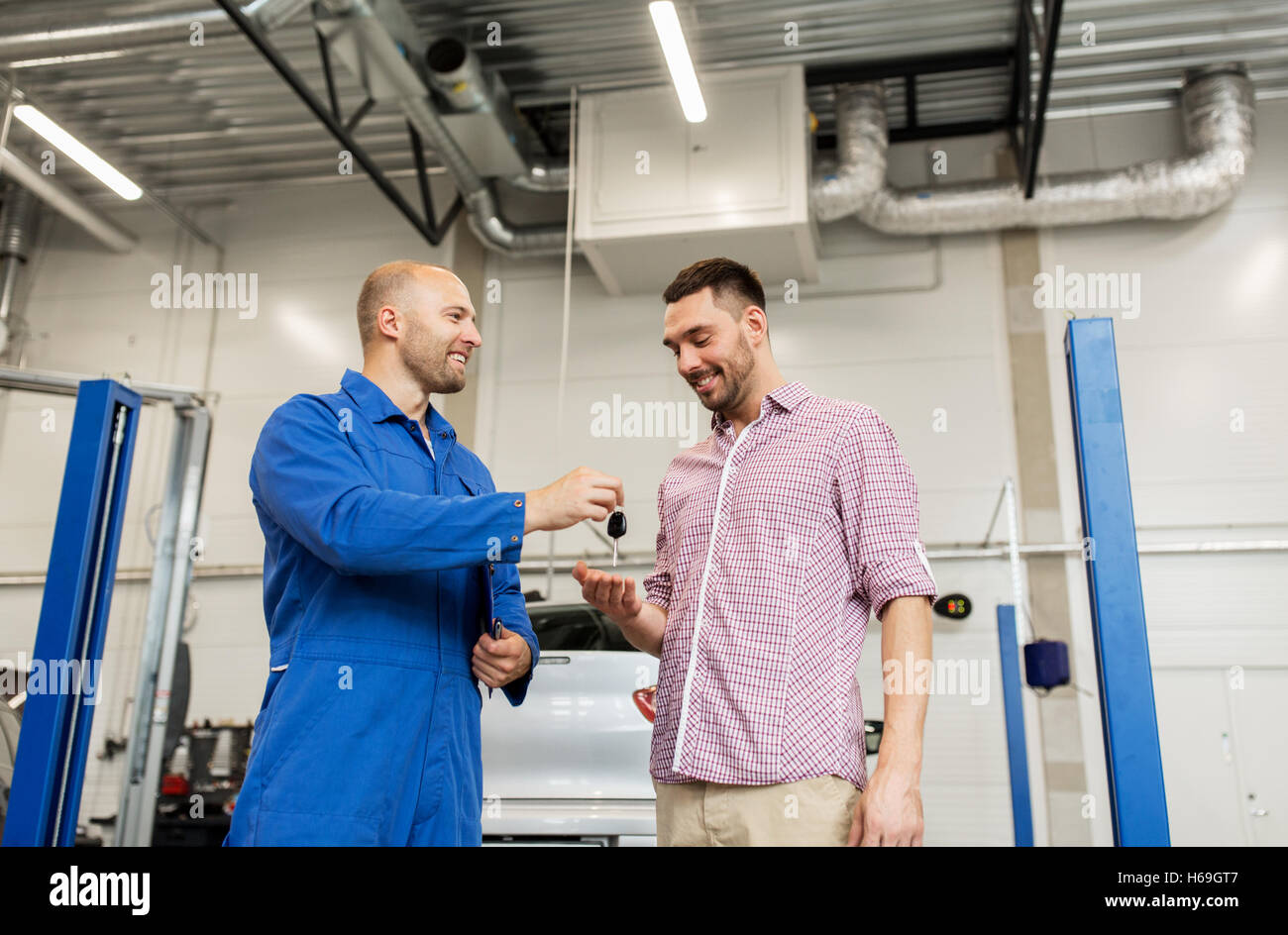 Mechanic giving car key man hi-res stock photography and images - Alamy