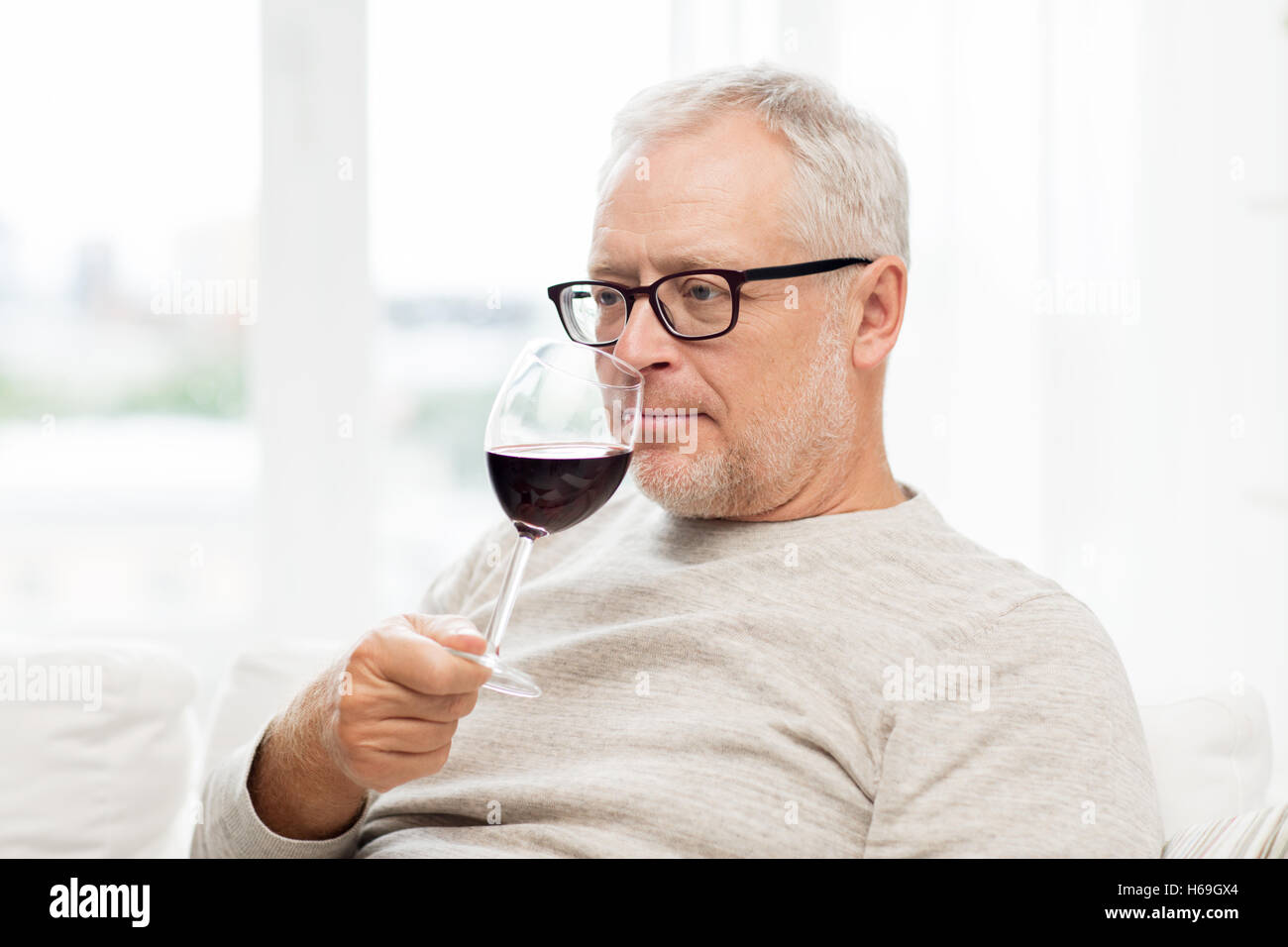 senior man drinking red wine from glass at home Stock Photo - Alamy
