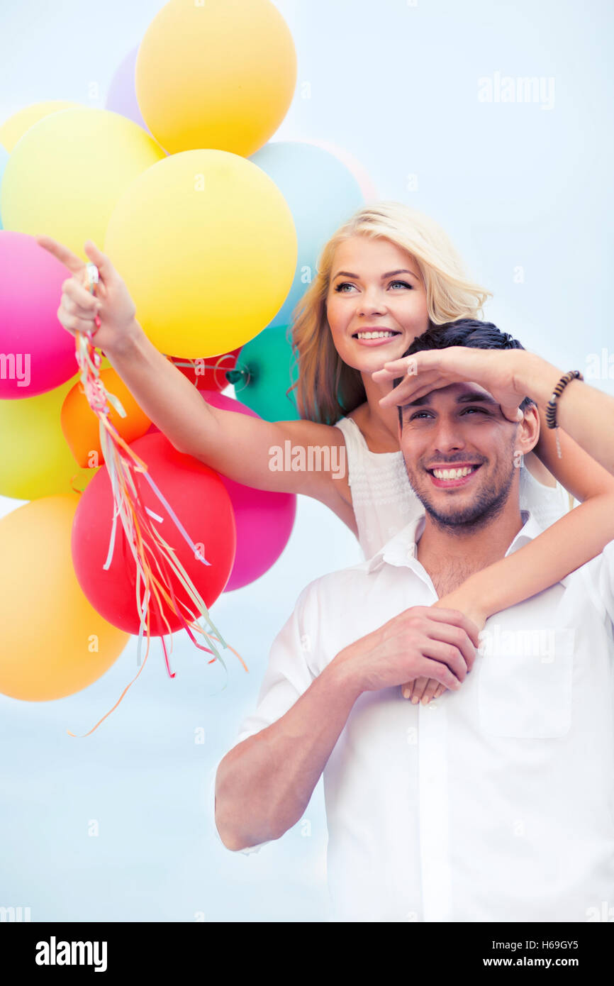 couple with colorful balloons at seaside Stock Photo - Alamy