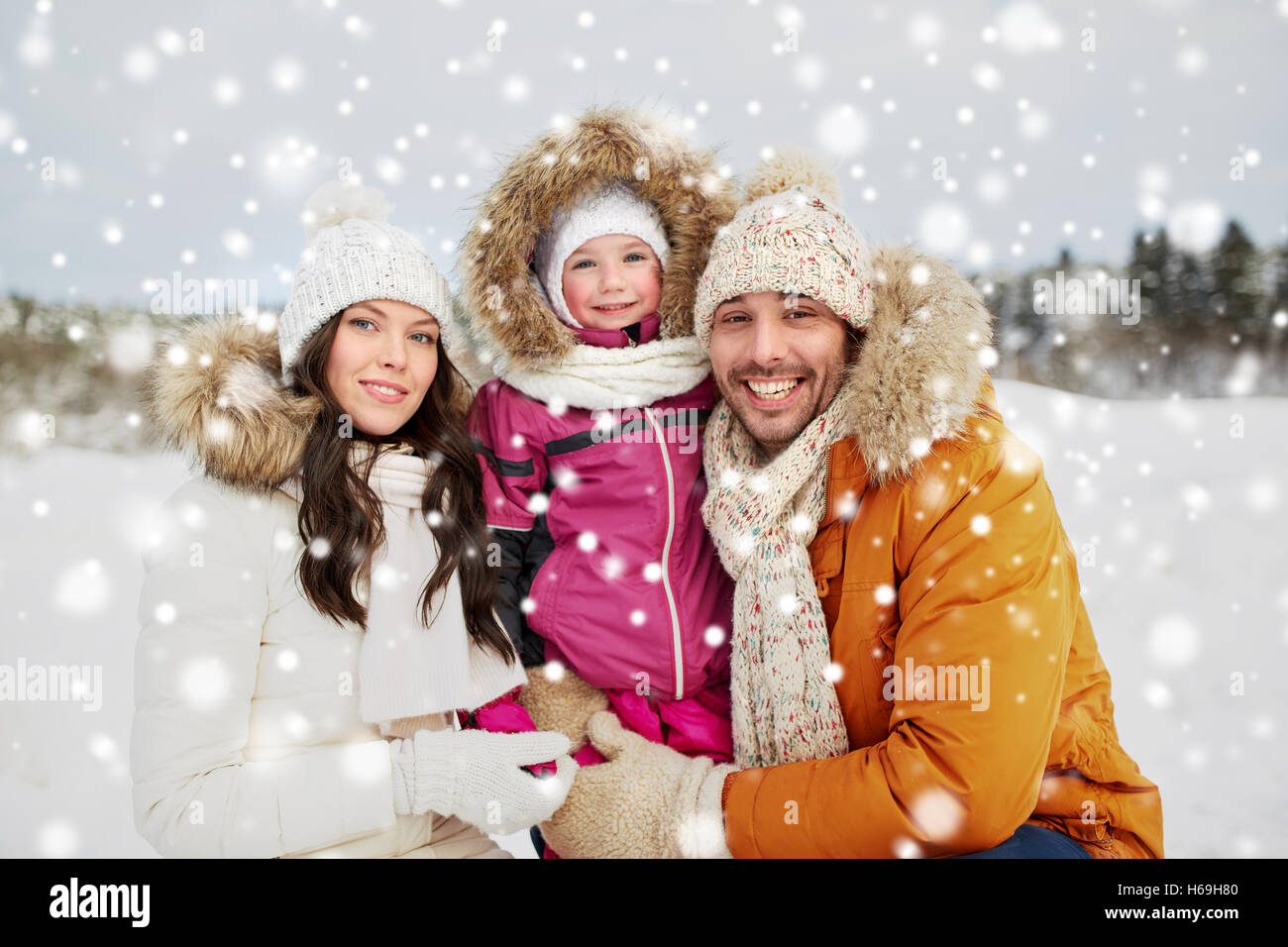 happy family with child in winter clothes outdoors Stock Photo