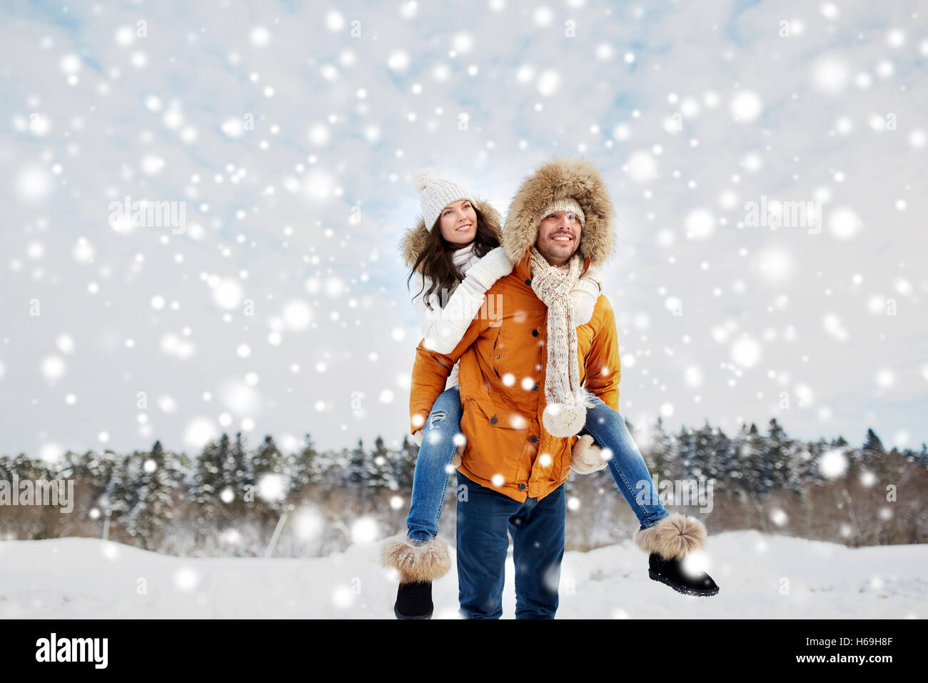 happy couple having fun over winter background Stock Photo - Alamy