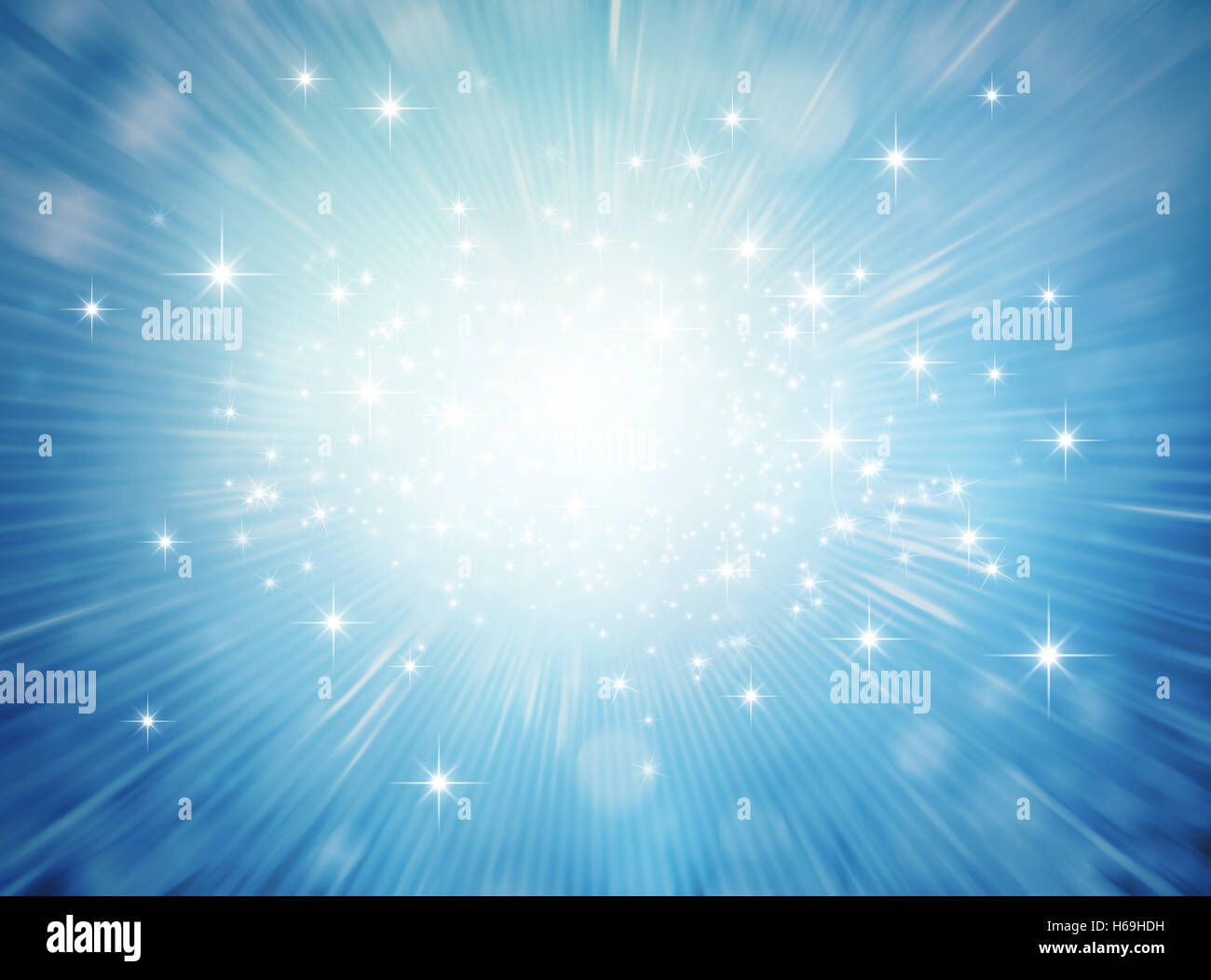 Festive bright light exploding inside a blue glittering background Stock Photo