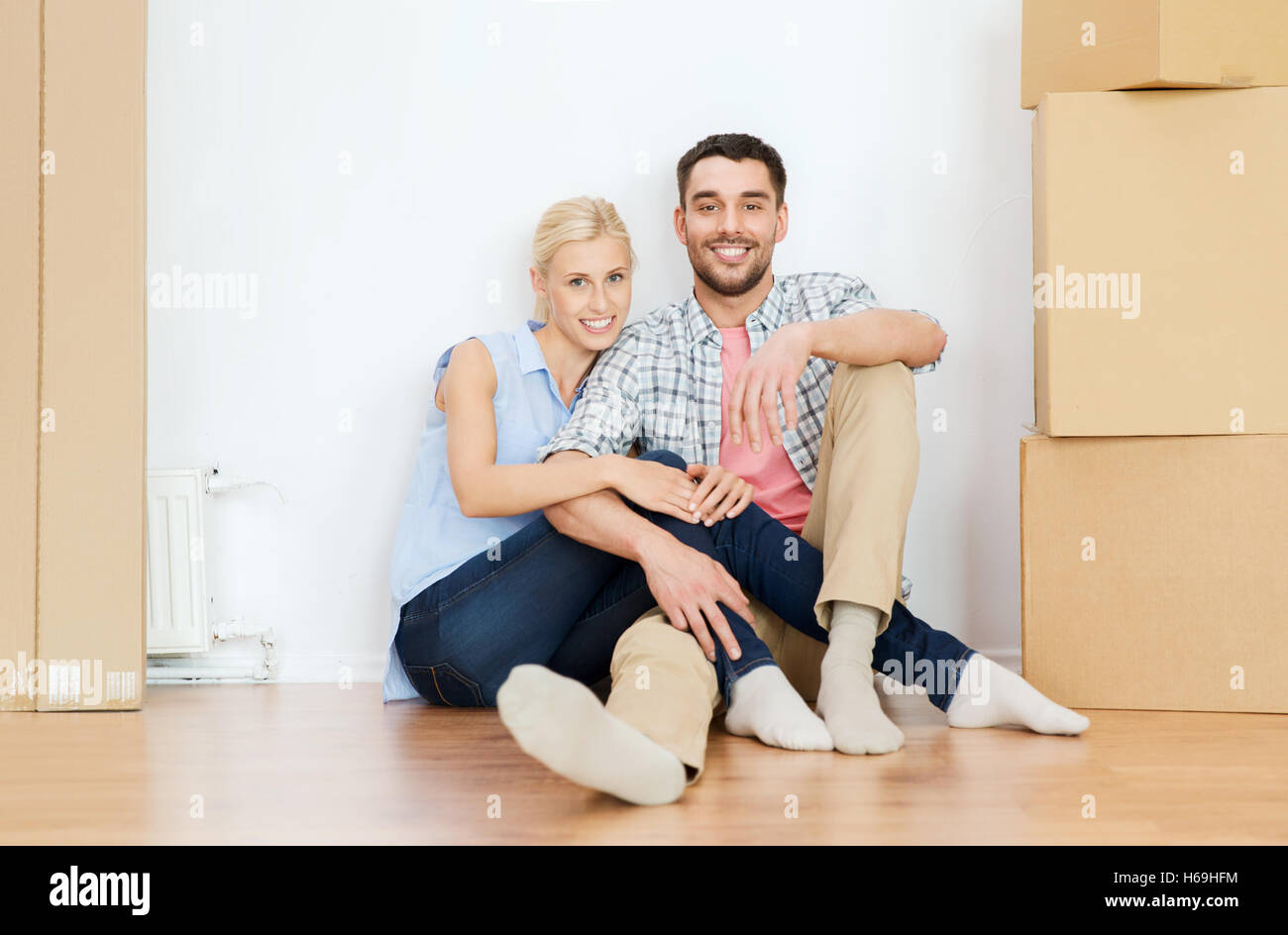 couple with cardboard boxes moving to new home Stock Photo - Alamy